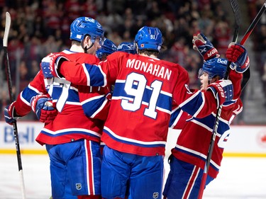 Canadiens right wing Cole Caufield (22) joins his teammates as they celebrate scoring against the Vancouver Canucks during NHL action in Montreal on Wednesday, Nov. 9, 2022.