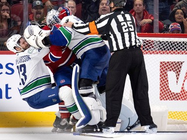 MONTREAL, QUE.: November 9, 2022 -- Montreal Canadiens right wing Brendan Gallagher (11) is hit by Vancouver Canucks defenseman Oliver Ekman-Larsson (23) and Vancouver Canucks goaltender Thatcher Demko (35) during NHL action in Montreal on Wednesday, November 9, 2022.