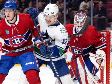 Canadiens goaltender Sam Montembeault (35) follows the play as Montreal Canadiens centre Christian Dvorak (28) and Vancouver Canucks right wing Vasily Podkolzin (92) spar in front of his net during NHL action in Montreal on Wednesday, Nov. 9, 2022.