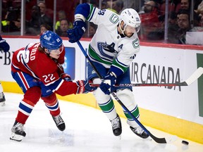 Canadiens right wing Cole Caufield (22) puts pressure on Vancouver Canucks defenceman Oliver Ekman-Larsson (23) during NHL action in Montreal on Wednesday, Nov. 9, 2022.