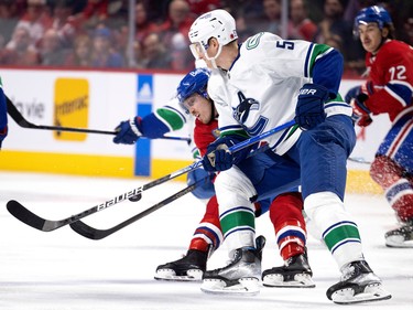 Canadiens right wing Brendan Gallagher (11) grimaces as Vancouver Canucks defenceman Tyler Myers (57) leans in on him during NHL action in Montreal on Wednesday, Nov. 9, 2022.