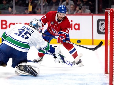 Canadiens left wing Jonathan Drouin (27) misses the net as Vancouver Canucks goaltender Thatcher Demko (35) looks back towards the puck during NHL action in Montreal on Wednesday, Nov. 9, 2022.