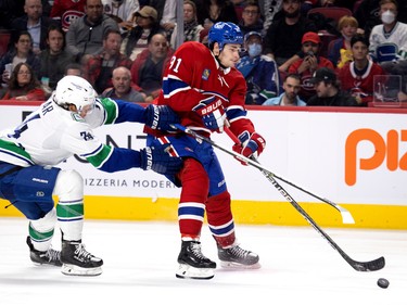 Canadiens centre Sean Monahan (91) gets a shot off despite Vancouver Canucks defenceman Ethan Bear (74) during NHL action in Montreal on Wednesday, Nov. 9, 2022.