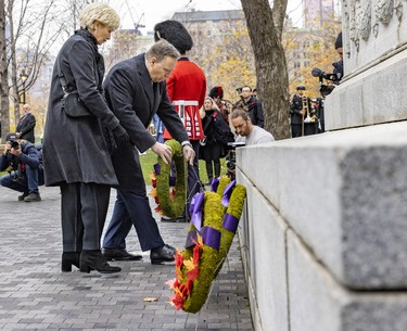Quebec Premier François Legault and wife, Isabelle Brais, lay a wreath at the cenotaph during Remembrance Day ceremony in Montreal on Friday, Nov. 11, 2022.