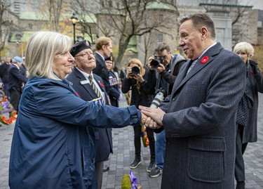 Quebec Premier François Legault speaks with Jean Irvine, representing the Silver Cross Mothers, prior to Remembrance Day ceremony in Montreal on Friday, Nov. 11,, 2022.