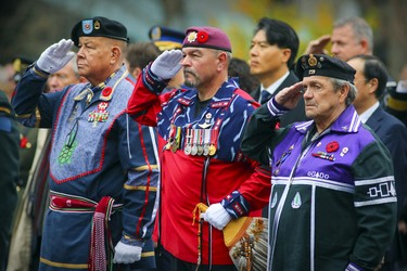 Mohawk veterans Eugene Montour, left, Tracy Cross and Louis Stacy, right, take part in Remembrance Day ceremony in Montreal on Friday, Nov. 11, 2022.