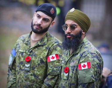Ranvir Singh wears a turban as part of his uniform as he watches Remembrance Day ceremony with Alin Pica in Montreal on Friday, Nov. 11, 2022.  The two are with Canadian Grenadier Guards.