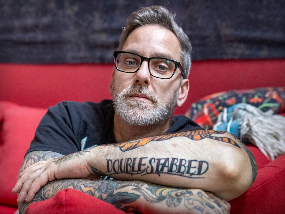 Maxime Canuel, seen here at his home in Montreal on Friday, Nov. 11, 2022, got a new tattoo after he recovered from being stabbed in the heart by a student while teaching class at John F. Kennedy High School last December.