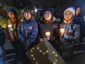 Members of the Chinese community attend a candlelight vigil for missing teenager Feng Tian to call attention to the boy's disappearance on Nov. 14, 2022.