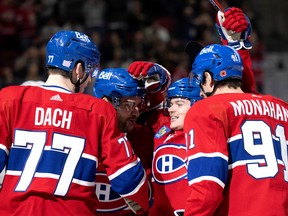 Montreal Canadiens right-winger Cole Caufield, centre, celebrates with teammates after the Habs scored on Vancouver Canucks goaltender Thatcher Demko in Montreal on Nov. 9, 2022.