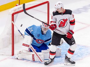 New Jersey Devils' Nathan Bastian watches teammate Jack Hughes's shot beat Montreal Canadiens Jake Allen during second period of National Hockey League game in Montreal Tuesday Nov. 15, 2022. The Habs were wearing their reverse retro jerseys for the game.