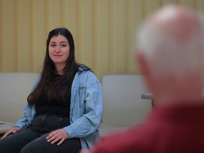 Rebecca Vigeant listens to a visitor at a Death Café at Beaconsfield library on Monday. Guests discussed death over coffee or tea, but Death Café is not intended to be a grief counselling session.