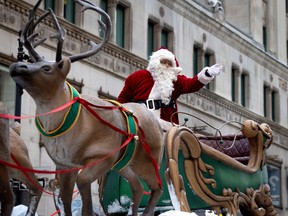 Santa waves to children as they line St. Catherine Street during the Santa Claus Parade in Montreal, Saturday, November 19, 2022.