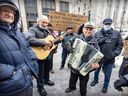 Nunzi Tiano on guitar joins Franco Guido on accordion as members of the Club de Bocce de l'Acadie protest outside Montreal city hall.