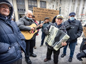 Nunzi Tiano on guitar joins Franco Guido on accordion as members of the Club de Bocce de l'Acadie protest outside Montreal city hall.