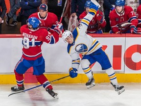 Montreal Canadiens centre Sean Monahan (91) and Buffalo Sabres defenseman Jacob Bryson (78) collide at centre ice during 3rd period NHL action at the Bell Centre in Montreal on Tuesday Nov. 22, 2022.