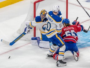 Buffalo Sabres goaltender Craig Anderson (41) bats the loose puck away with Montreal Canadiens left wing Michael Pezzetta (55) in front during 3rd period NHL action at the Bell Centre in Montreal on Tuesday Nov. 22, 2022.