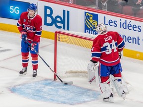 Montreal Canadiens defenceman Kaiden Guhle (21) takes the puck from goaltender Jake Allen (34) after the Buffalo Sabres soundly defeated the Montreal Canadiens 7-2 during NHL action at the Bell Centre in Montreal on Tuesday Nov. 22, 2022.