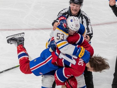 Montreal Canadiens centre Jake Evans (71) and Buffalo Sabres left wing Jeff Skinner (53) tangle in the Montreal end during 2nd period NHL action at the Bell Centre in Montreal on Tuesday Nov. 22, 2022.