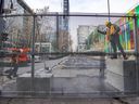 Workers secure a section of the three-metre-high security fence around the Palais des congrès, ahead of the COP15 conference Dec. 7-19 in Montreal.