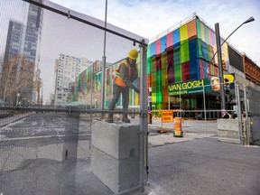 A worker secures a section of the three-metre-high security fence around the Palais des congrés in Montreal Nov. 24, 2022, ahead of the COP15 conference happening in December.