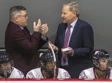 Montreal Force's head coach Peter Smith, right, has a conversation with assistant coach Pierre Alain during the second period of the team's first Premier Hockey League home game against the Metropolitan Riveters in Verdun on Saturday, Nov. 26, 2022.