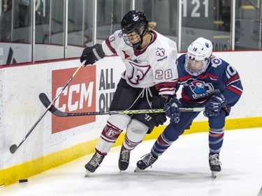 Montreal Force's Catherine Dubois holds off a check by Metropolitan Riveters' Kendall Cornine during the Force's first Premier Hockey League home game in Verdun on Saturday, Nov. 26, 2022.