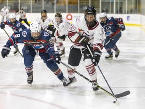 Montreal Force's Jade Downie-Landry is pressured by Metropolitan Riveters Kelly Babstock, left, during the Force's first Premier Hockey League home game in Verdun on Saturday, Nov.  26, 2022.