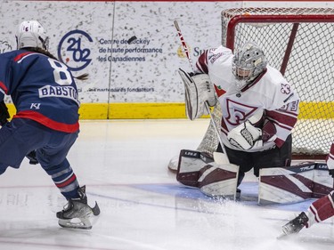 Montreal Force's Tricia Deguire makes a save off a shot by Metropolitan Riveters' Kelly Babstock during the Force's first Premier Hockey League home game in Verdun on Saturday, Nov. 26, 2022.