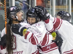 Montreal Force's Brooke Stacey, left, and Jade Downie-Landry celebrate teammate Ann-Sophie Bettez's goal against the Metropolitan Riveters during the Force's first Premier Hockey League home game in Verdun on Saturday, Nov.  26, 2022.