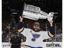 St. Louis Blues defenseman Joel Edmundson holds up the Stanley Cup after the Blues' win over the Boston Bruins at TD Garden in Boston on June 12, 2019.