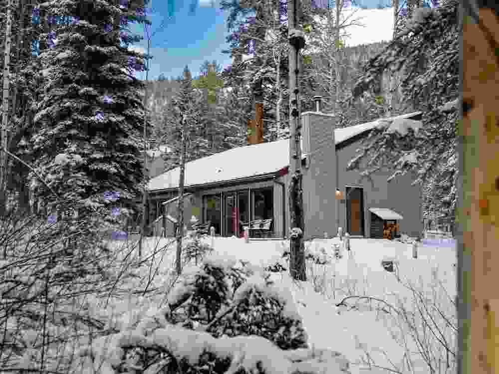 A blanket of snow ensures peacefulness at Juniper Hotel’s woodland cabins.