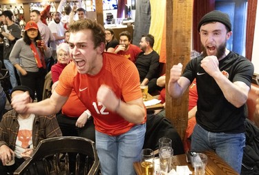 Fans at Montreal's Burgundy Lion pub react as Canada is awarded a penalty kick against Belgium on Nov. 23, 2022