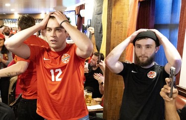 Fans at Montreal's Burgundy Lion pub react as Canada's Alphonso Davies misses a penalty kick against Belgium on Nov. 23, 2022