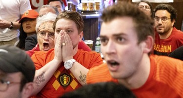 Belgium fans watch their team play Canada at at Montreal's Burgundy Lion pub on Nov. 23, 2022