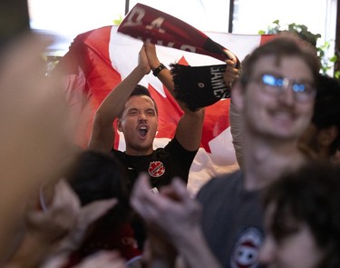 Fans at Montreal's Burgundy Lion pub cheer the start of Canada's World Cup match against Belgium on Nov. 23, 2022