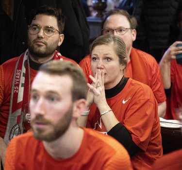 MONTREAL, QUE.: November 23, 2022 -- A nervous Canadian fan follows closely as a crowded pub watch Canada vs Belgium play in the World Cup, Burgundy Lion in Montreal on Wednesday, November 23, 2022.