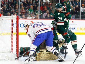 Rem Pitlick #32 of the Montreal Canadiens competes for the puck as Marc-Andre Fleury #29 and Matt Dumba #24 of the Minnesota Wild defend their net in the first period of the game at Xcel Energy Center on November 1, 2022 in St Paul, Minnesota.