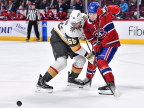 Montreal Canadiens winger Cole Caufield battles Keegan Kolesar for the puck during the third period at the Bell Centre in Montreal on Nov. 5, 2022.
