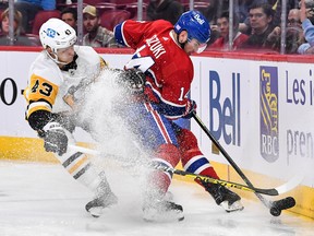 Nick Suzuki of the Montreal Canadiens and Danton Heinen of the Pittsburgh Penguins skate after the puck during the second period at the Bell Centre on Nov. 12, 2022, in Montreal.