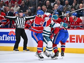 MONTREAL, CANADA - NOVEMBER 29: Matt Nieto #83 of the San Jose Sharks is caught between Joel Armia #40 and Johnathan Kovacevic #26 of the Montreal Canadiens during the first period at Centre Bell on November 29, 2022 in Montreal, Quebec, Canada.