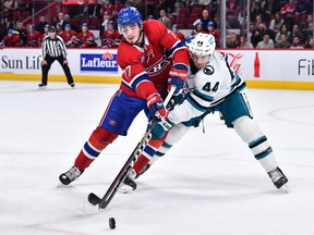 Canadiens' Kirby Dach, left, battles Sharks' Marc-Edouard Vlasic during second period Tuesday night at the Bell Centre.