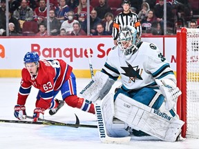 Sharks goaltender Kaapo Kahkonen prepares for a shot while Canadiens forward Evgenii Dadonov lurks nearby during game Tuesday night at the Bell Centre.