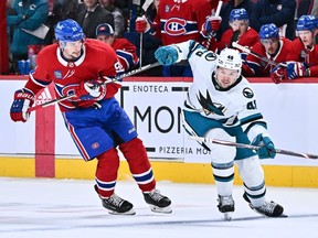 Sean Monahan of the Montreal Canadiens and Tomas Hertl of the San Jose Sharks pursue the puck during the third period at the Bell Centre in Montreal on Nov. 29, 2022.