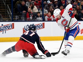 Montreal Canadiens centre Nick Suzuki controls the puck against Marcus Bjork of the Columbus Blue Jackets during the first period at Nationwide Arena in Columbus, Ohio, on Nov. 17, 2022.