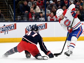 Nick Suzuki #14 of the Montreal Canadiens controls the puck against Marcus Bjork #47 of the Columbus Blue Jackets during the first period at Nationwide Arena on Nov. 17, 2022 in Columbus, Ohio.
