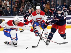 Yegor Chinakhov #59 of the Columbus Blue Jackets takes a shot on goal against Johnathan Kovacevic #26 and Christian Dvorak #28 of the Montreal Canadiens during the second period at Nationwide Arena on Nov. 17, 2022 in Columbus, Ohio.