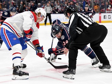 Cole Sillinger #34 of the Columbus Blue Jackets and Christian Dvorak #28 of the Montreal Canadiens face off during the second period at Nationwide Arena in Columbus, Ohio, on Nov. 17, 2022.