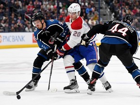 Juraj Slafkovsky #20 of the Montreal Canadiens competes for the puck with Jack Roslovic #96 and Erik Gudbranson #44 of the Columbus Blue Jackets during the first period at Nationwide Arena on Nov. 23, 2022 in Columbus, Ohio.