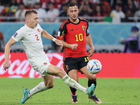 Canadian defender Alistair Johnston fights for the ball with Belgium forward Eden Hazard during World Cup action on Wednesday, Nov. 23, 2022 in Qatar.